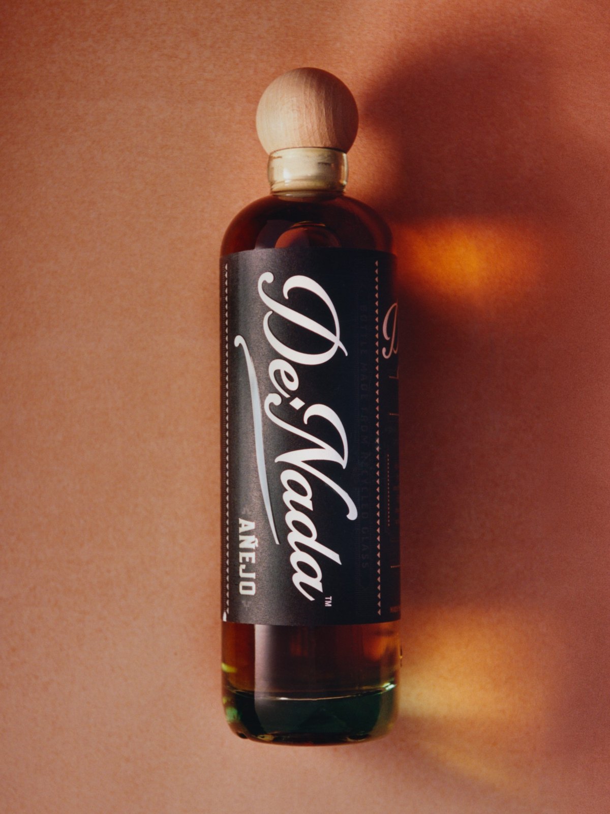 The Añejo lying on terracotta in late light