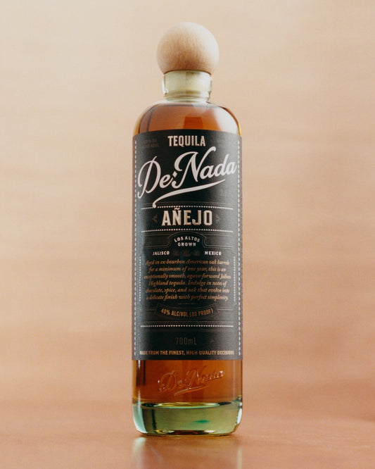 De Nada Añejo on a peach wall